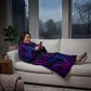 Woman relaxing on a couch in The Dream Long in Galaxy while using her phone, showcasing cozy comfort on a rainy day indoors.