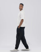 Model walking while wearing The Dream Pants in Black.