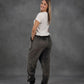 Rear three-quarter view of a woman wearing Dream Pants in Dark Gray, showcasing the relaxed silhouette and ultra-soft fabric.