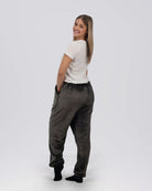 Rear three-quarter view of a woman wearing Dream Pants in Dark Gray, showcasing the relaxed silhouette and ultra-soft fabric.