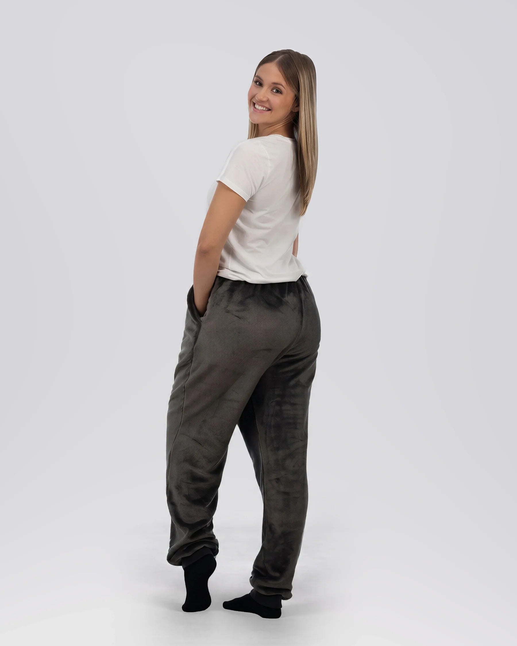 Rear three-quarter view of a woman wearing Dream Pants in Dark Gray, showcasing the relaxed silhouette and ultra-soft fabric.