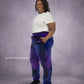 Woman wearing Dream Pants in Galaxy, showcasing the relaxed fit, side pockets, and all-over purple and blue cosmic print.