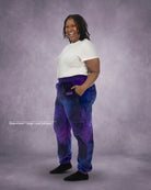 Woman wearing Dream Pants in Galaxy, showcasing the relaxed fit, side pockets, and all-over purple and blue cosmic print.
