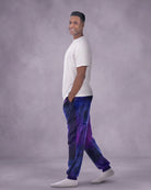 Man wearing Dream Pants in Galaxy in side profile, showcasing the relaxed silhouette, cuffed ankles, and galaxy print design.