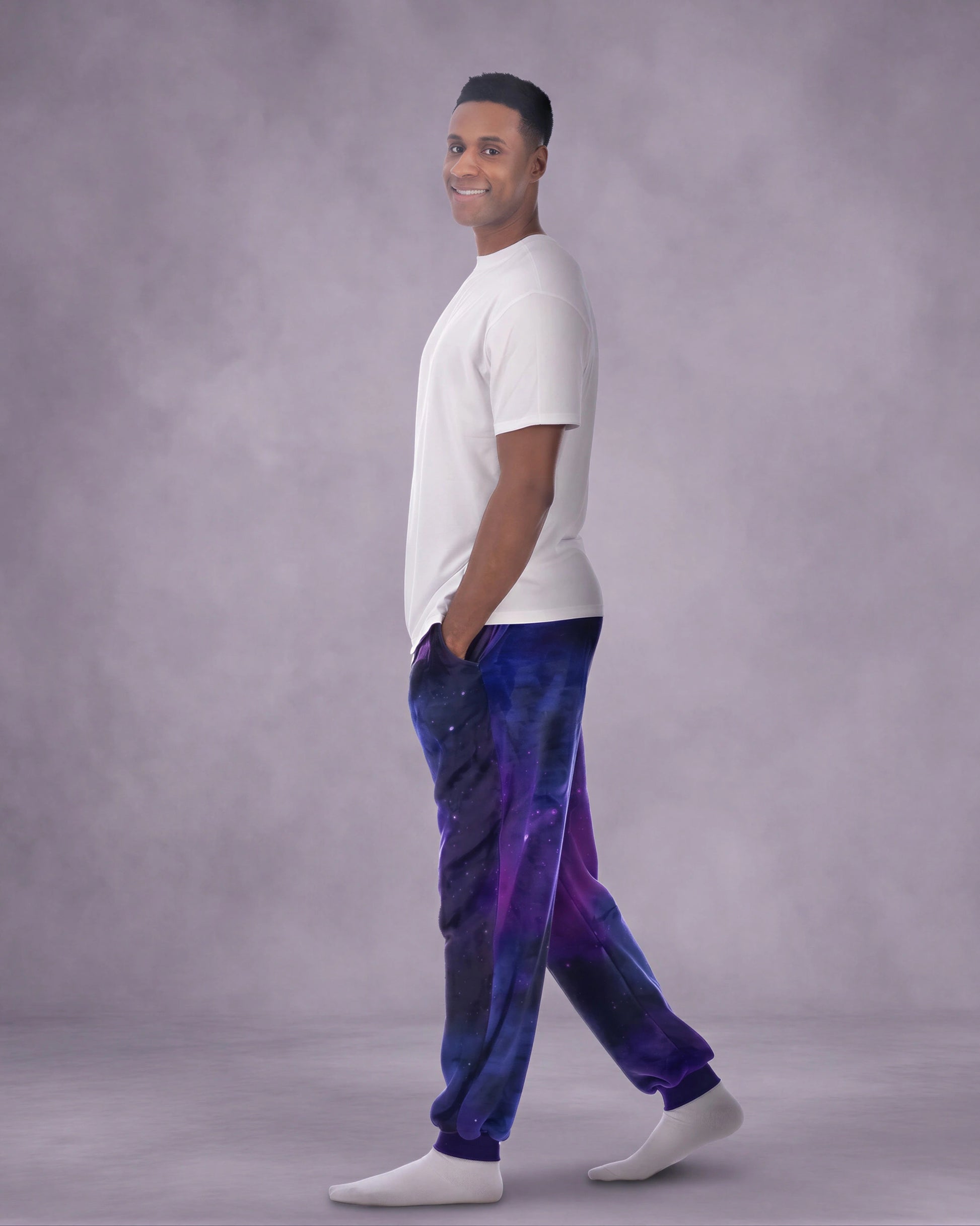 Man wearing Dream Pants in Galaxy in side profile, showcasing the relaxed silhouette, cuffed ankles, and galaxy print design.