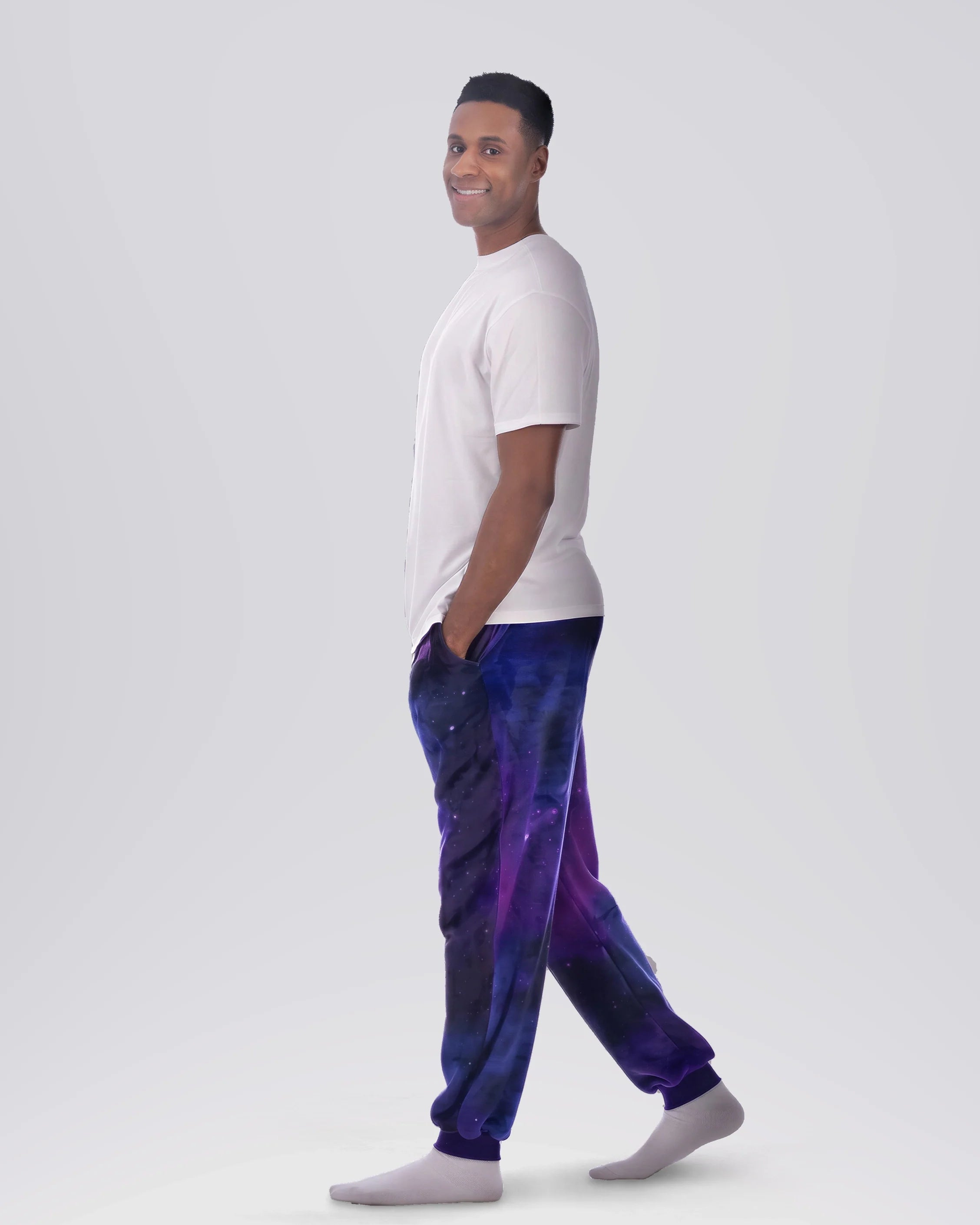 Man wearing Dream Pants in Galaxy in side profile, showcasing the relaxed silhouette, cuffed ankles, and galaxy print design.
