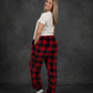 Rear three-quarter view of a woman wearing Dream Pants in Red Plaid, highlighting the relaxed silhouette and all-over buffalo check design.