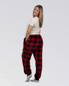 Rear three-quarter view of a woman wearing Dream Pants in Red Plaid, highlighting the relaxed silhouette and all-over buffalo check design.
