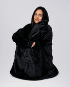 Model relaxing in The Dream in Black, showing the oversized fit and soft drape.