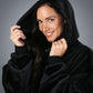 Close-up of The Dream wearable blanket in Black, featuring the oversized hood, ultra-soft microfiber fabric, and lightweight comfort-focused design.