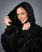 Close-up of The Dream wearable blanket in Black, featuring the oversized hood, ultra-soft microfiber fabric, and lightweight comfort-focused design.