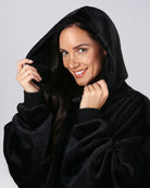 Close-up of The Dream in Black with the oversized hood up, highlighting its relaxed fit and DreamHaven™ fabric.
