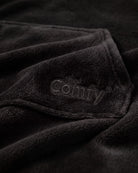 Close-up of The Dream in Black showing DreamHaven™ fabric, the kangaroo pocket, and tonal Comfy embroidery.