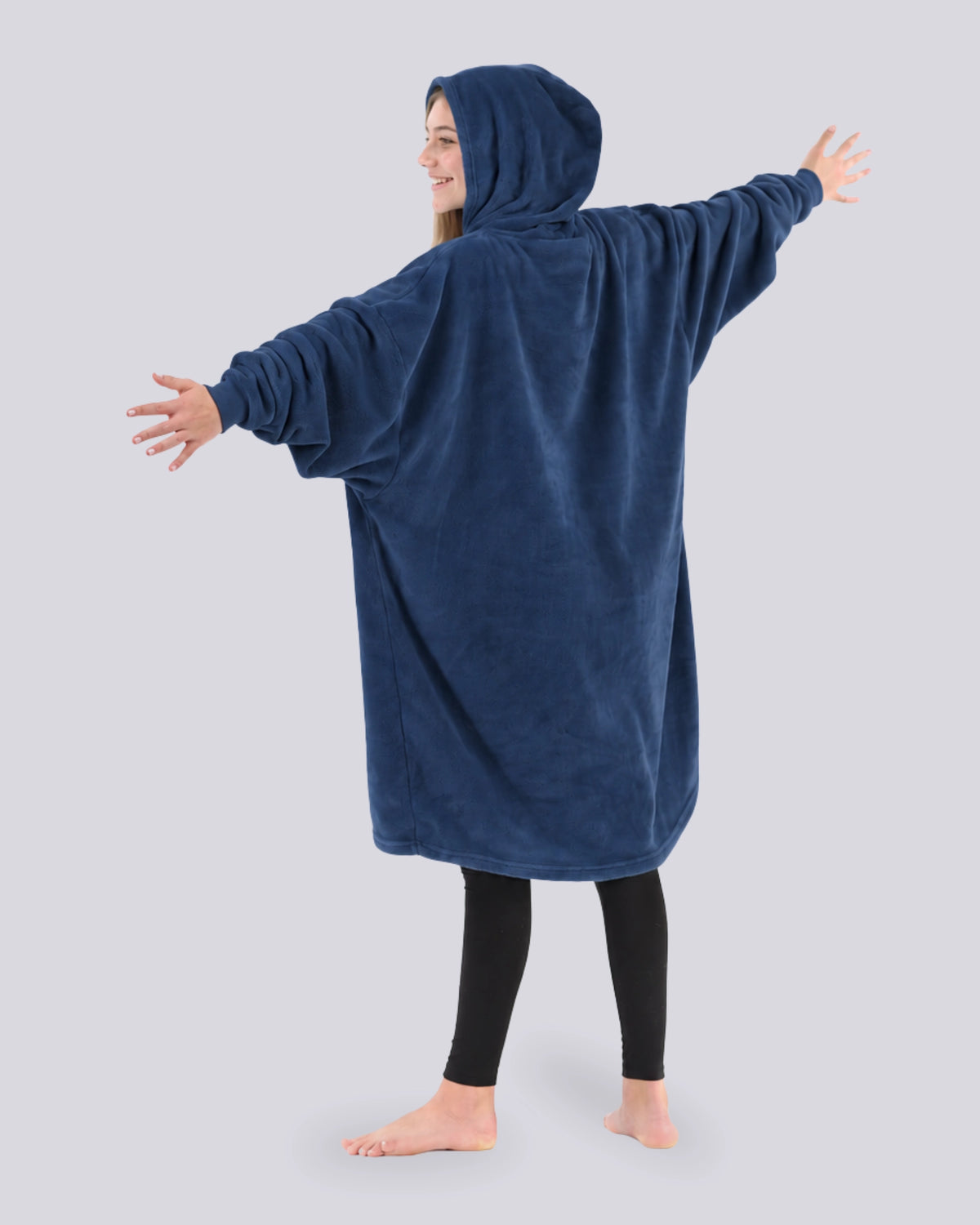 Back view of a model wearing The Dream in blue. The model's arms are stretched out.