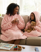 lifestyle shot of the a mom and daughter sitting on the couch wearing the dream in blush and dream jr in blush