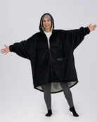 Model wearing The Original Full-Zip in Black with arms extended to show the oversized fit.