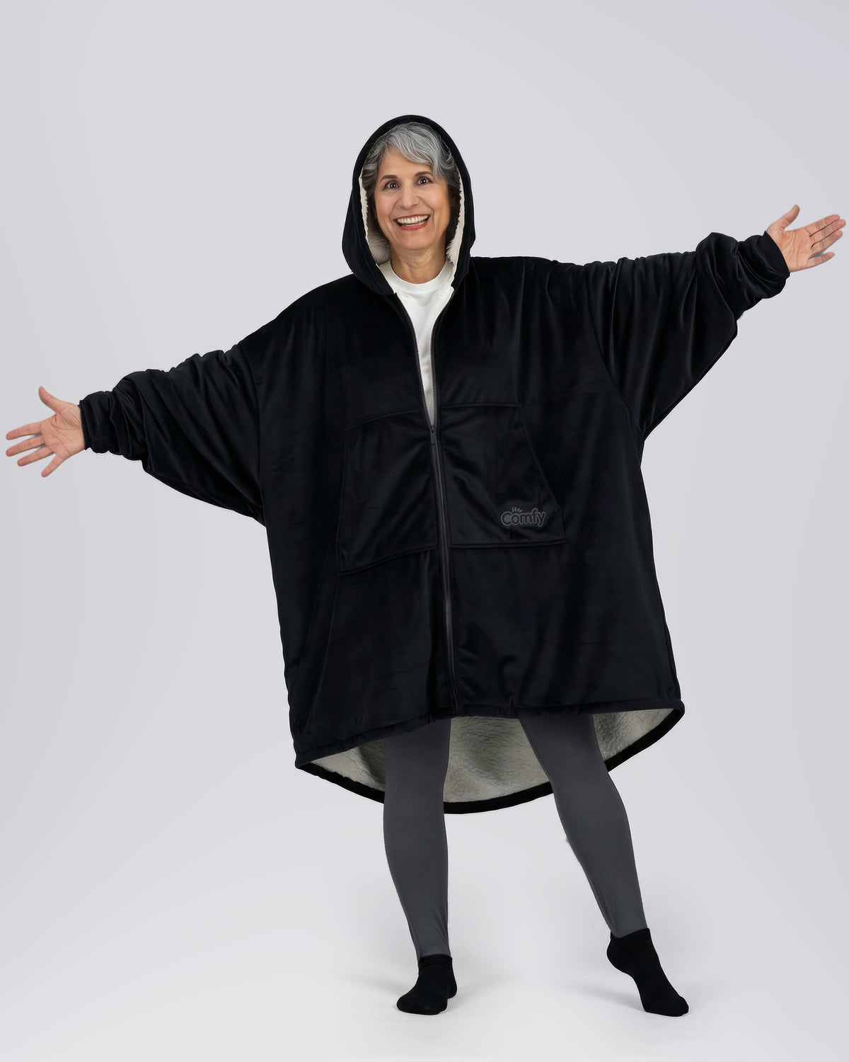 Model wearing The Original Full-Zip in Black with arms extended to show the oversized fit.