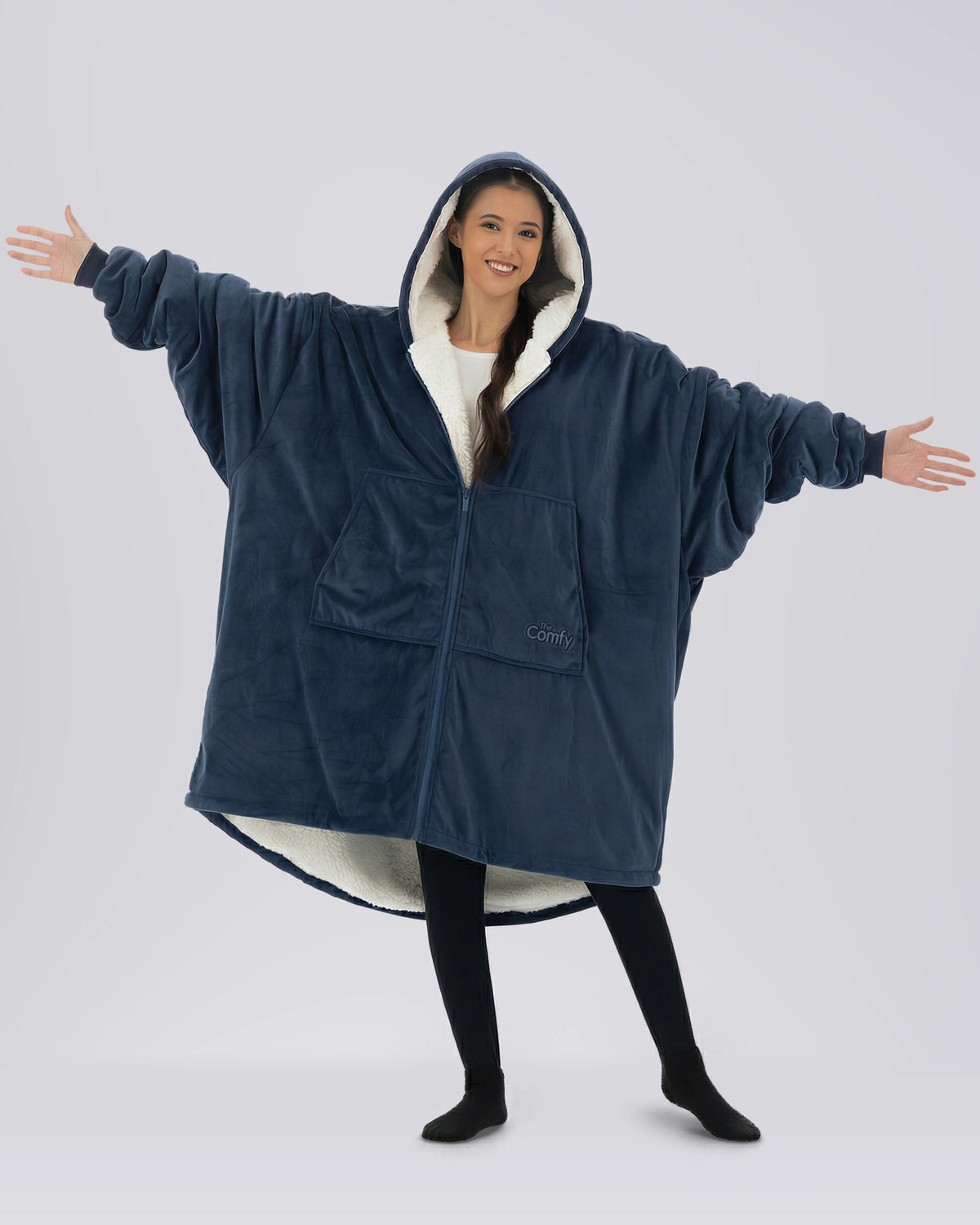 Model wearing The Original Full-Zip in Blue with arms extended to show the oversized fit.