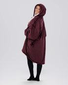 Side view of The Original Full-Zip wearable blanket in Burgundy highlighting hood, longer coverage, and relaxed silhouette.