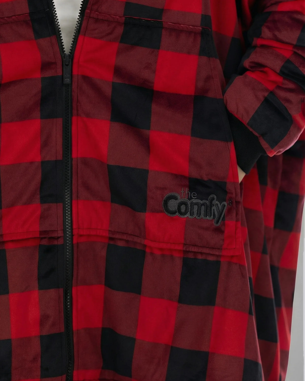Close-up of The Original Full-Zip in Red Plaid showing its fabric and embroidered logo.