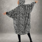 Back view of The Original Full-Zip in Snow Leopard with arms extended, highlighting the oversized wearable blanket silhouette, roomy fit, and full-coverage design.
