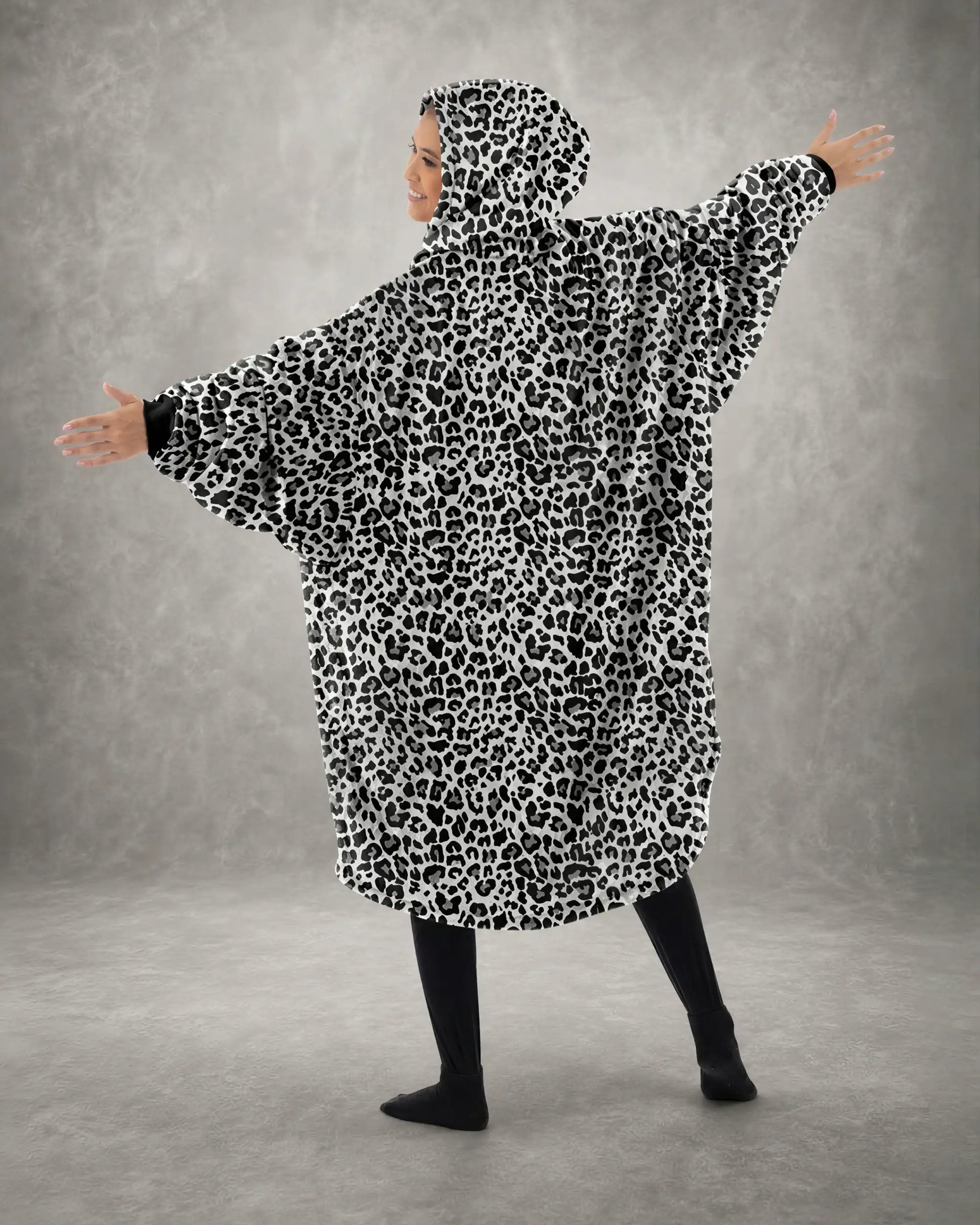Back view of The Original Full-Zip in Snow Leopard with arms extended, highlighting the oversized wearable blanket silhouette, roomy fit, and full-coverage design.