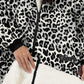 Close-up detail of The Original Full-Zip in Snow Leopard featuring the full-length zipper, kangaroo pocket, Velveluxe™ exterior, embroidered logo, and ultra-soft CloudSherpa™ lining.