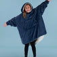 Child wearing The Original Jr. Blue wearable blanket with arms outstretched, highlighting the roomy design and oversized coverage.