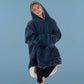 Child wearing The Original Jr. Blue wearable blanket in a relaxed pose, featuring the oversized kangaroo pocket and CloudSherpa™ lining.