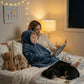 Child wearing The Original Jr. Blue wearable blanket while reading with a parent at bedtime, illustrating cozy family moments and story time comfort.