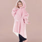 Child wearing The Original Jr. Blush wearable blanket with hood up, featuring the oversized silhouette and front kangaroo pocket.