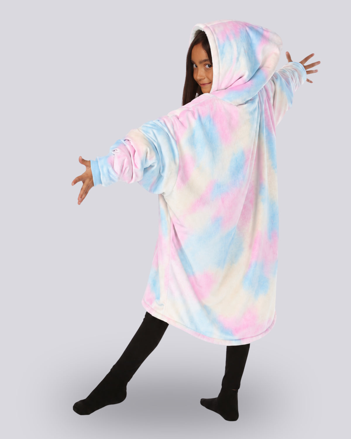 Child wearing The Original Jr. Cotton Candy Tie Dye wearable blanket with her arms streatch out showing the back side of the hoodie blanket. 
