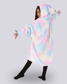 Child wearing The Original Jr. Cotton Candy Tie Dye wearable blanket with her arms stretched out showing the back side of the hoodie blanket. 