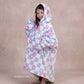 Child wearing The Original Jr. Flower Checkered wearable blanket with CloudSherpa™ lining, showcasing the playful checkered floral pattern and oversized fit.