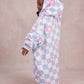 Side and back view of a child wearing The Original Jr. Flower Checkered wearable blanket, showcasing the oversized silhouette and hood design.