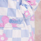 Close-up of The Original Jr. Flower Checkered wearable blanket, highlighting the soft fabric, floral checkered pattern, and embroidered logo detail.