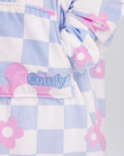 Close-up of The Original Jr. Flower Checkered wearable blanket, highlighting the soft fabric, floral checkered pattern, and embroidered logo detail.