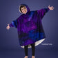 Child wearing The Original Jr. Galaxy wearable blanket with arms outstretched, showcasing the oversized fit, celestial-inspired print, and CloudSherpa™ lining.