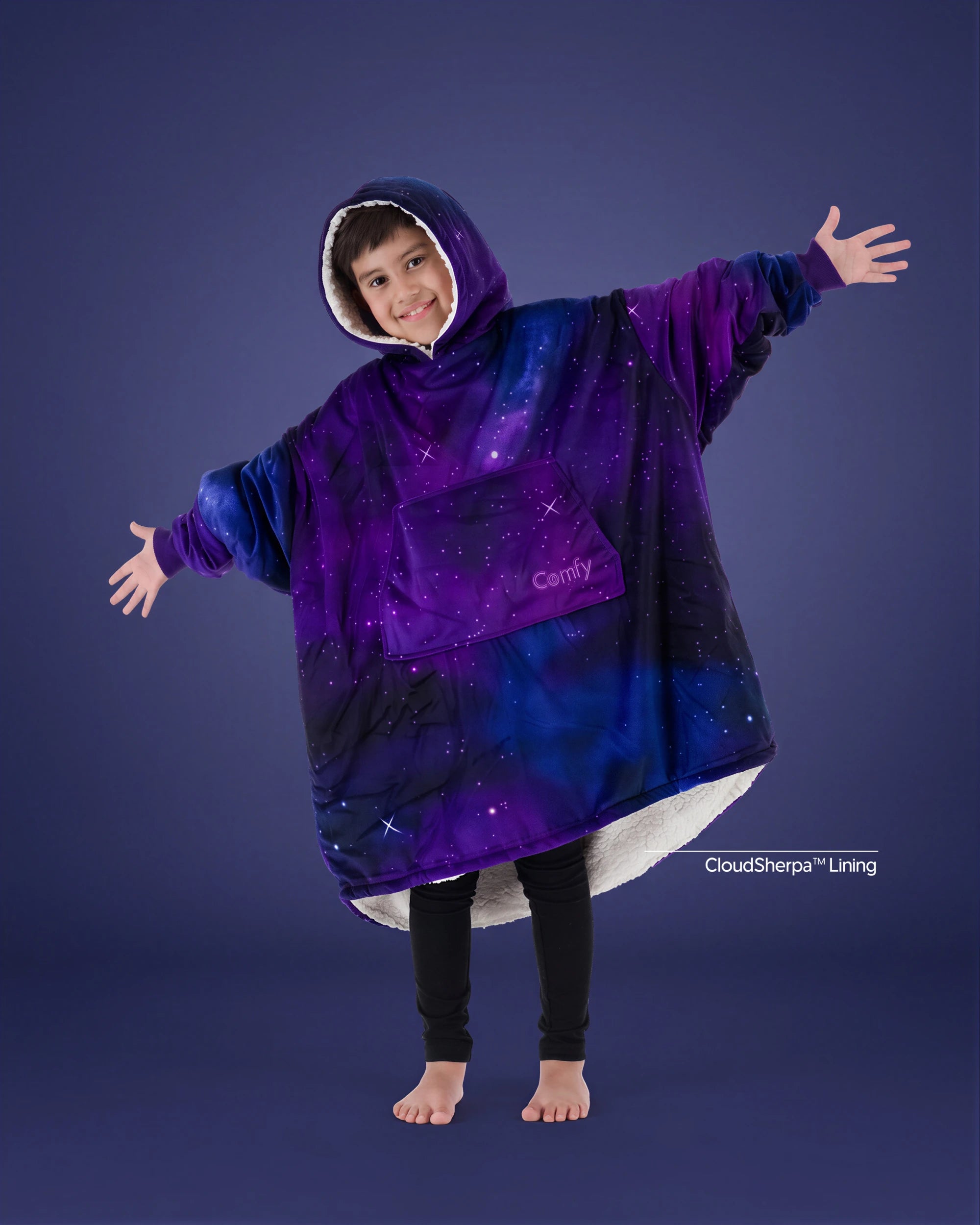 Child wearing The Original Jr. Galaxy wearable blanket with arms outstretched, showcasing the oversized fit, celestial-inspired print, and CloudSherpa™ lining.