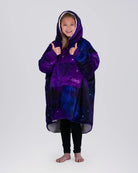 Child giving a thumbs up while wearing The Original Jr. Galaxy wearable blanket, showcasing all-day comfort and cozy coverage.