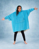 Rear view of a child wearing The Original Jr. Neon Aqua wearable blanket, highlighting the oversized hood and generous coverage.