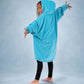 Child wearing The Original Jr. Neon Aqua wearable blanket with arms outstretched, showcasing the roomy silhouette and full-body comfort.