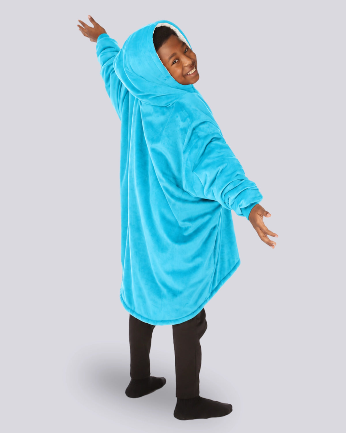 The Original Jr wearable blanket in Neon Aqua, back view with arm stretched out.
