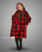 Child wearing The Original Jr. Red Plaid wearable blanket with CloudSherpa™ lining, featuring the classic buffalo plaid pattern, oversized hood, and cozy all-day comfort.