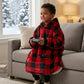 Child relaxing on the couch and playing video games while wearing The Original Jr. Red Plaid wearable blanket, perfect for cozy afternoons, movie marathons, and staying warm indoors.