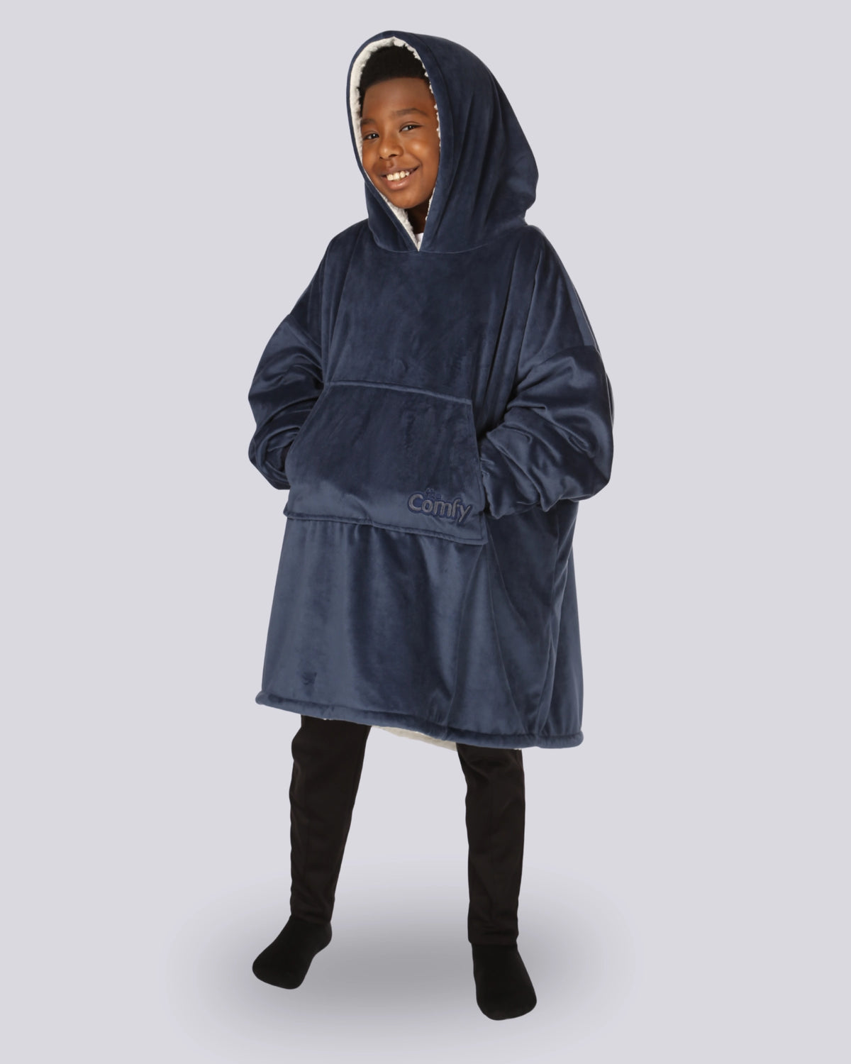Child wearing The Original Jr. wearable blanket in Blue with CloudSherpa™ lining, with hand in pocket and showing the oversized fit designed for cozy comfort.