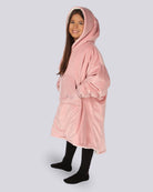 Child wearing The Original Jr. Blush wearable blanket in a side facing pose, highlighting the oversized pocket and length