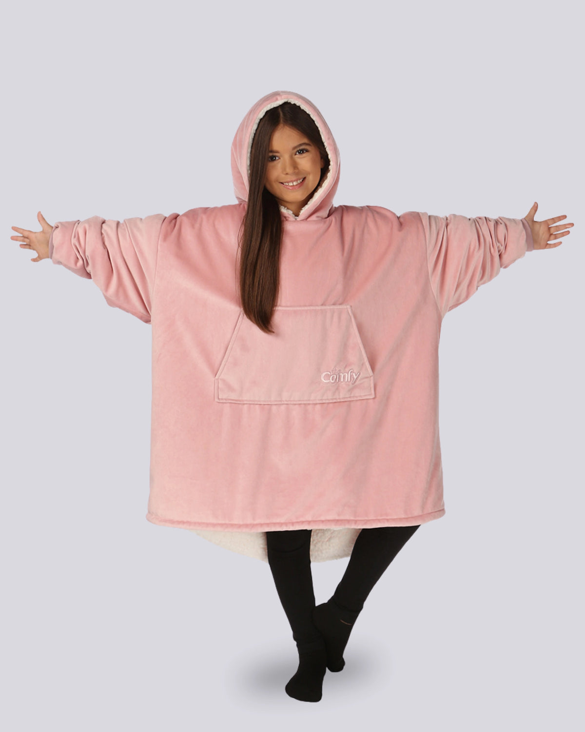Child wearing The Original Jr. Blush wearable blanket in a front pacing pose with arms stretched out, highlighting the oversized fit.