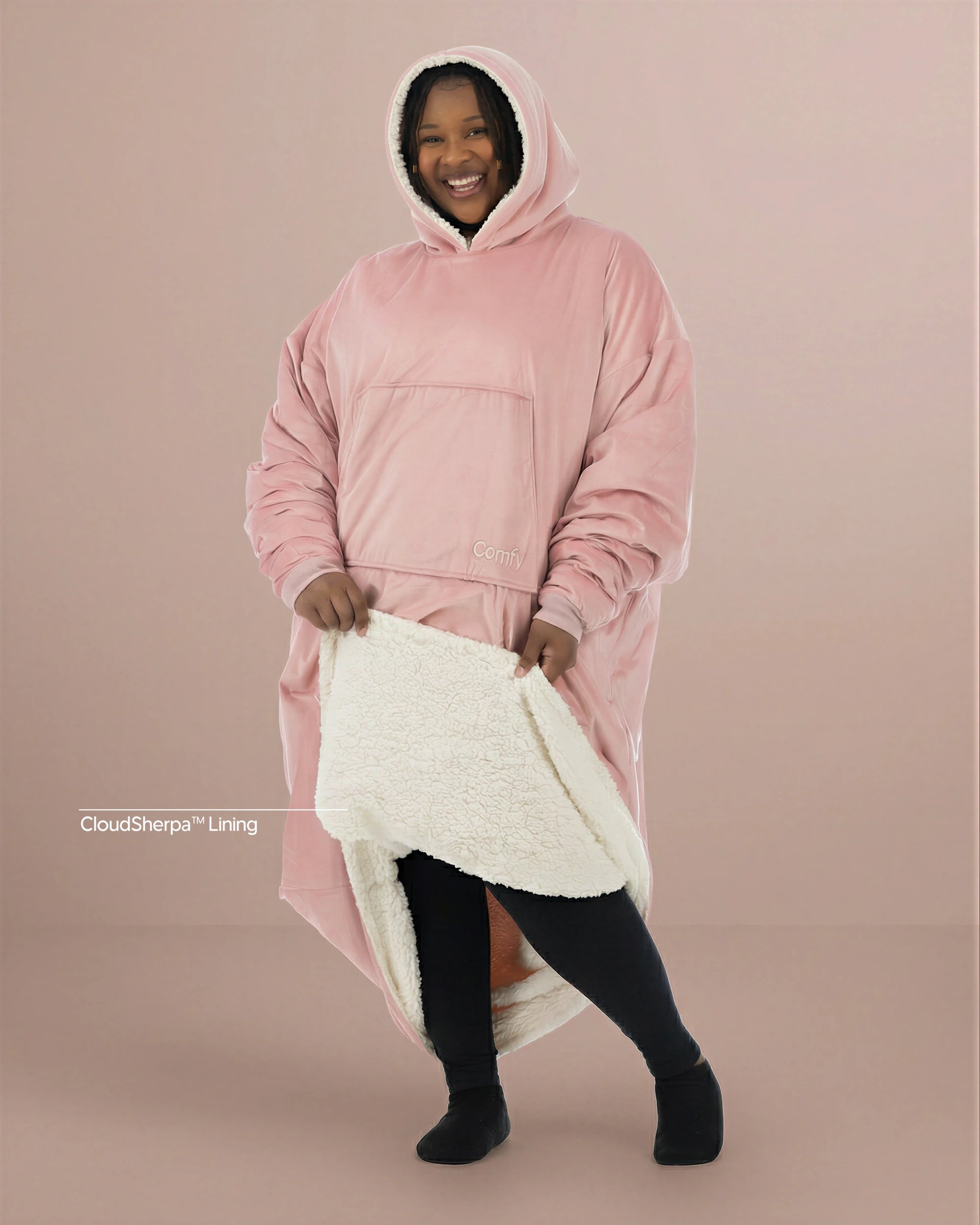 Woman wearing The Comfy Original Long in blush with CloudSherpa™ lining, front view showing oversized fit and sherpa interior.