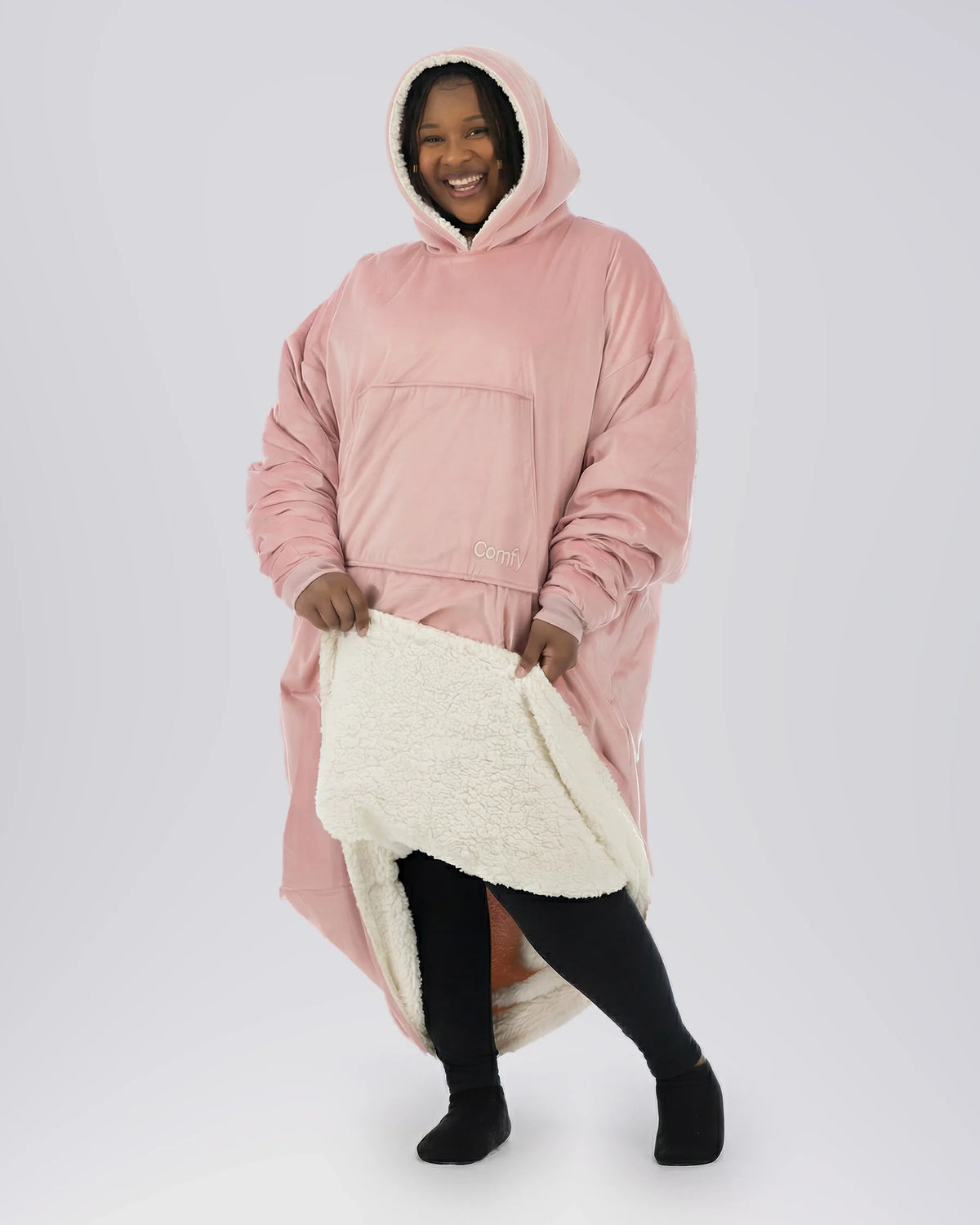 Woman wearing The Comfy Original Long in blush with CloudSherpa™ lining, front view showing oversized fit and sherpa interior.